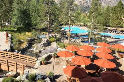 a resort with orange umbrellas and a swimming pool at Spa and Ski-InandOut Access! Everline Resort Studio in Olympic Valley