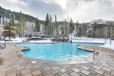a large swimming pool with blue water in a resort at Spa and Ski-InandOut Access! Everline Resort Studio in Olympic Valley
