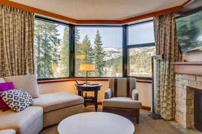 a living room with a couch and a fireplace at Ski-InandSki-Out and Mtn Views! Everline Resort Condo in Olympic Valley