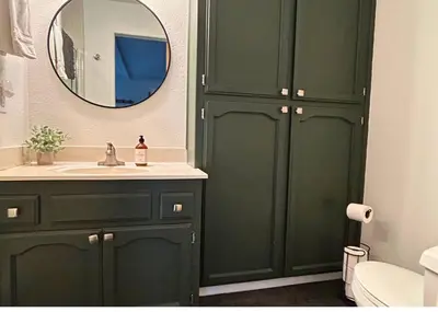 a green bathroom with a sink and a mirror at My Side of the Mountain Rest Recharge Repeat in Shaver Lake