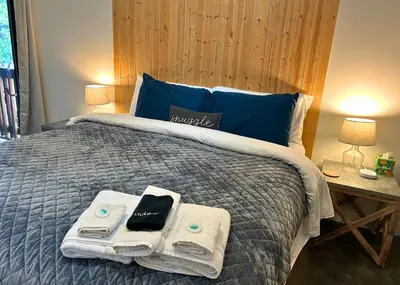 a bedroom with a bed with towels on it at My Side of the Mountain Rest Recharge Repeat in Shaver Lake
