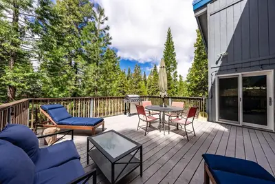 a patio with chairs and a table on a deck at My Side of the Mountain Rest Recharge Repeat in Shaver Lake