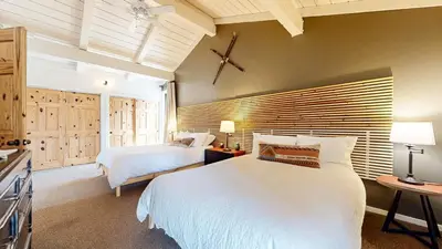 a bedroom with a large white bed and a window at Villa de los Pinos #09 condo in Mammoth Lakes
