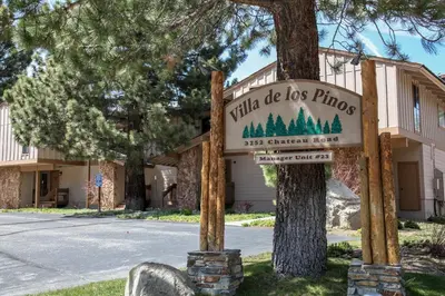 a sign for a little do less phono in front of a tree at Villa de los Pinos #09 condo in Mammoth Lakes