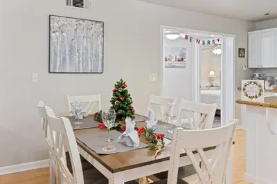 a dining room table with a christmas tree on it at Midtown Apartment with Private Parking and King Bed in Sacramento