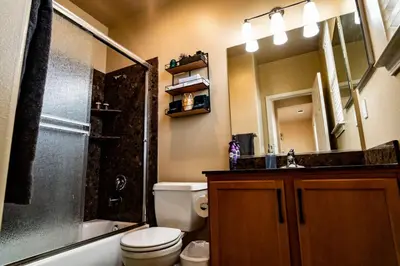 a bathroom with a toilet and a sink and a shower at Eat-Sleep-Stroll-Repeat! Walkable Midtown 2BR Home in Reno