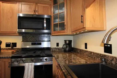 a kitchen with a stove and a microwave at HNC0628 - Stagecoach Escape condo in Stateline