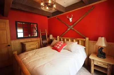 a bedroom with a bed with a red wall at HNC0628 - Stagecoach Escape condo in Stateline