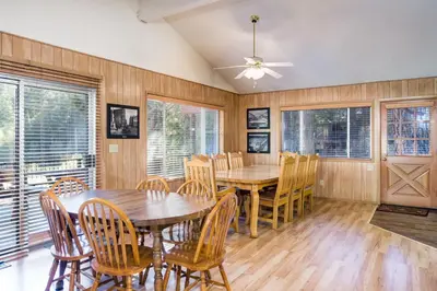 a dining room with a wooden table and chairs at Yosemite's Riverfront Retreat in Wawona