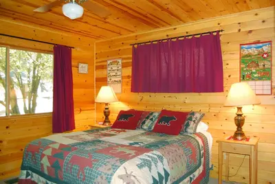 a bedroom with a bed in a log cabin at 9N Fox Hollow in Wawona