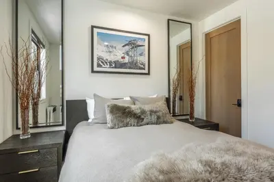a bedroom with a bed and a large mirror at New Luxury 4BR /3BA Obsidian Reserve #110 – Hot Tub, 2-Car Garage, Pool Table, Mount Views! in Mammoth Lakes