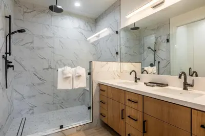 a bathroom with two sinks and a shower at New Luxury 4BR /3BA Obsidian Reserve #110 – Hot Tub, 2-Car Garage, Pool Table, Mount Views! in Mammoth Lakes