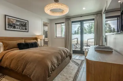 a bedroom with a bed and a large window at New Luxury 4BR /3BA Obsidian Reserve #110 – Hot Tub, 2-Car Garage, Pool Table, Mount Views! in Mammoth Lakes