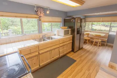 a kitchen with a sink and a microwave at Near Yosemite Bass Lake Cabin with Hot Tub, Lake View, Pet Friendly in Bass Lake