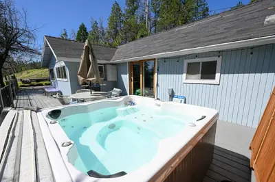 a hot tub on the deck of a house at Near Yosemite Bass Lake Cabin with Hot Tub, Lake View, Pet Friendly in Bass Lake