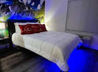 a bedroom with a large bed with blue lights at The Rivet in Reno