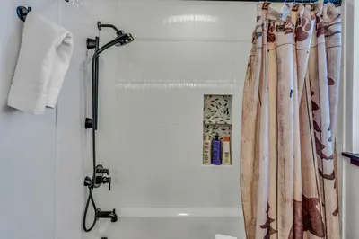 a shower with a shower curtain in a bathroom at The Lazy Bear Northstar Resort Truckee in Truckee