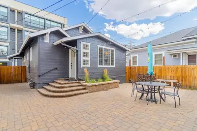 a gray house with a table and chairs in a courtyard at Modern 1-BR Apartment Close to Downtown Vibes in Reno