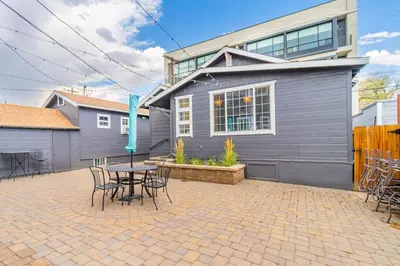 a patio with a table and chairs in front of a house at Stylish 2-Bedroom walking distance to Downtown in Reno
