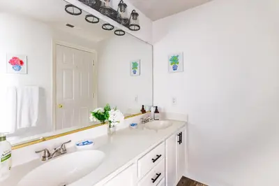 a bathroom with two sinks and a large mirror at Designer Home conveniently located in Reno NV in Reno