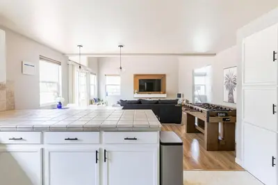 a kitchen and living room with white cabinets at Designer Home conveniently located in Reno NV in Reno