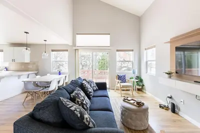 a living room with a blue couch and a kitchen at Designer Home conveniently located in Reno NV in Reno