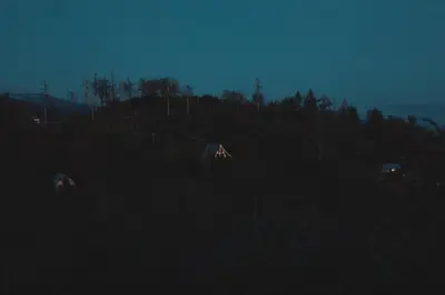a group of houses in a field at night at Secluded rustic 2-bedroom cabin on private land in Miramonte