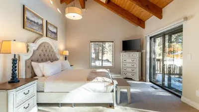 a bedroom with a large bed and a tv at Views Mins to Skiing Lake Incline Village Incline Serenity by AvantStay in Incline Village