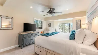 a bedroom with a large bed and a flat screen tv at Views Mins to Skiing Lake Incline Village Incline Serenity by AvantStay in Incline Village