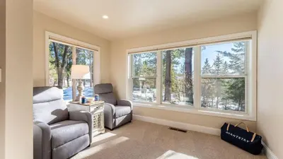 a living room with two chairs and two windows at Views Mins to Skiing Lake Incline Village Incline Serenity by AvantStay in Incline Village