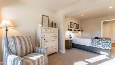 a bedroom with a bed and a chair and a dresser at Views Mins to Skiing Lake Incline Village Incline Serenity by AvantStay in Incline Village