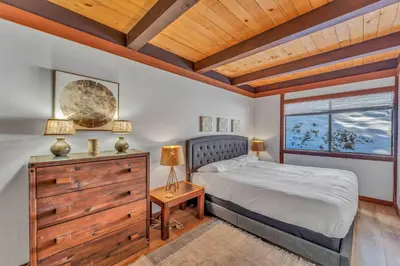 a bedroom with a bed and a window at Chinquapin Condo Retreat - Walk to the Lake in Tahoe City