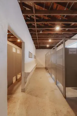 an empty hallway with lockers in a building at Cosy yurt at a nature retreat in Miramonte