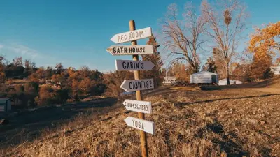a street sign with arrows pointing in different directions at Cosy yurt at a nature retreat in Dunlap CA in Miramonte