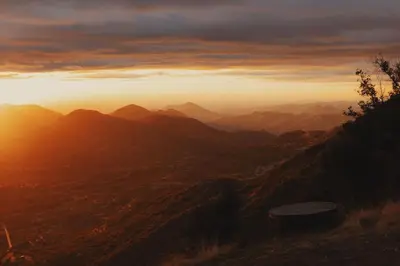 a view of a mountain range with the sun setting at Cosy yurt at a nature retreat in Dunlap CA in Miramonte