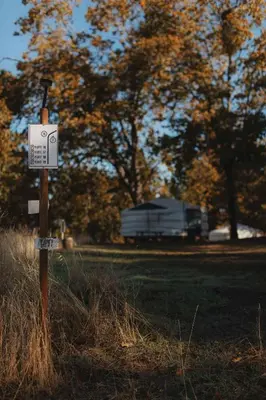 a sign in the grass in a field at Glamping yurt at a nature retreat near Sequoia in Miramonte