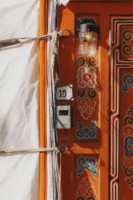 an orange door with a light on it at Glamping yurt at a nature retreat Sequoia Highland in Miramonte