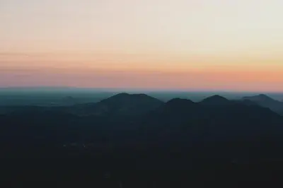 a view of a mountain range at sunset at Secluded rustic 2-bedroom cabin on nature retreat in Miramonte
