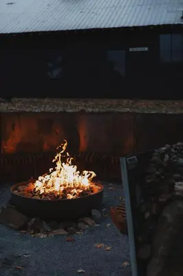 a fire in a pot on the ground at Secluded rustic 3-bedroom cabin on private land in Miramonte