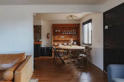 a dining room and kitchen with a table and chairs at Spacious 4-bedroom cabin on secluded private land in Miramonte