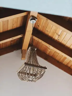 a chandelier hanging from a ceiling in a room at Secluded rustic 1-bedroom cabin on private land in Miramonte