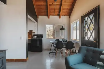 a living room with a couch and a table at Secluded rustic 1-bedroom cabin on private land in Miramonte