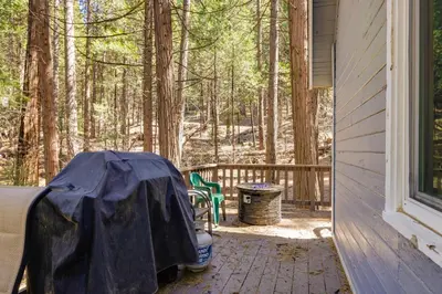 a porch with a tent and a table and chairs at Hike, Ski and Sip Arnold Cabin 4 Mi to State Park! in Arnold