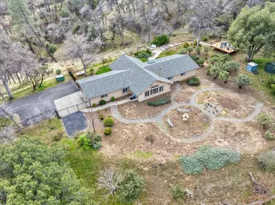 an aerial view of a house with a yard at New Big Sky Cabin at Yosemite w/ VIEWS, hot tub, firepit, and more in Oakhurst