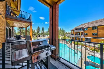 a grill on the balcony of a house with a swimming pool at Pinnacle Stateline Resort BBQ Hot Tub Pool Zalanta 214 in Stateline