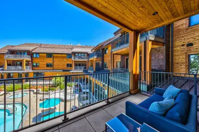 a balcony with a couch and a swimming pool at Pinnacle Stateline Resort BBQ Hot Tub Pool Zalanta 214 in Stateline
