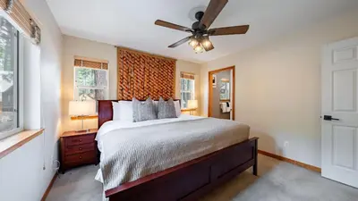 a bedroom with a bed and a ceiling fan at Stylish Truckee Retreat Deck Near Lake Skiing Moraine by AvantStay in Truckee