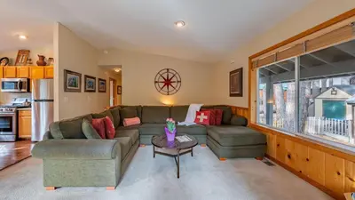 a living room with a couch and a table at Stylish Truckee Retreat Deck Near Lake Skiing Moraine by AvantStay in Truckee