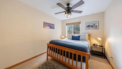 a bedroom with a bed and a ceiling fan at Stylish Truckee Retreat Deck Near Lake Skiing Moraine by AvantStay in Truckee