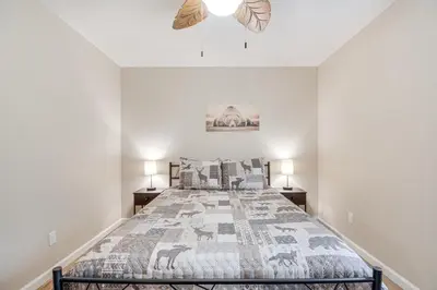 a bedroom with a large bed and two lamps at Coulterville Home with Gazebo Near Lakes and Hiking! in Coulterville